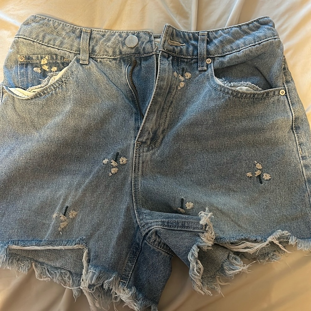 Medium wash mom style jean shorts with daisy print